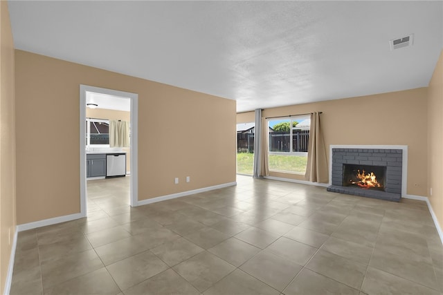 1018 N Millard Ave, Rialto, CA 92376 - unfurnished living room with baseboards, tile patterned floors, and a brick fireplace