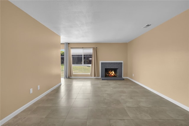 1018 N Millard Ave, Rialto, CA 92376 - unfurnished living room featuring baseboards, a brick fireplace, and tile patterned floors