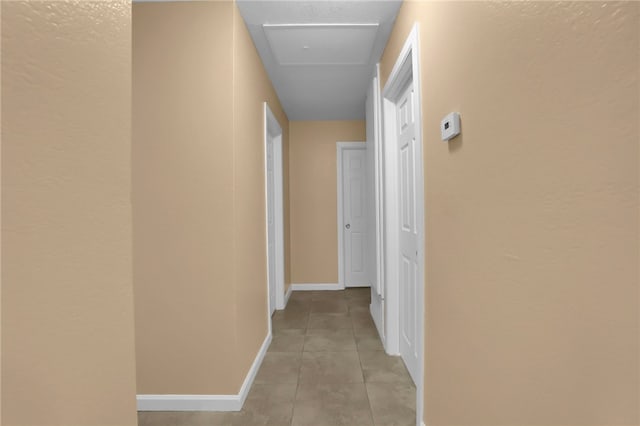 1018 N Millard Ave, Rialto, CA 92376 - hallway with light tile patterned floors, baseboards, and a textured wall
