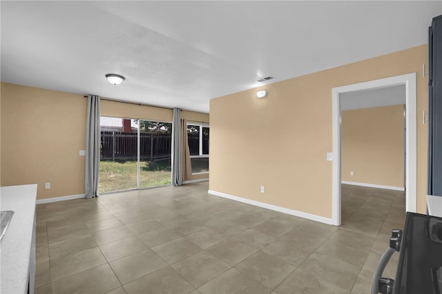 1018 N Millard Ave, Rialto, CA 92376 - spare room featuring tile patterned flooring and baseboards