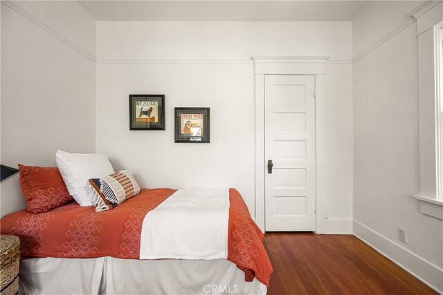 528 E Palmyra Ave, Orange, CA 92866 - bedroom with dark wood-style flooring and baseboards