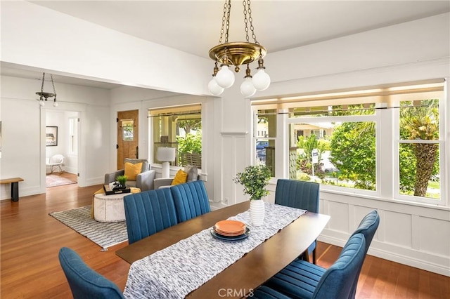 528 E Palmyra Ave, Orange, CA 92866 - dining space with wood finished floors, plenty of natural light, a chandelier, and a decorative wall