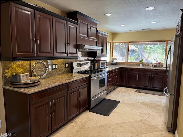 28726 Macklin Ave, Canyon Country, CA 91387 - kitchen featuring stainless steel appliances, a sink, under cabinet range hood, backsplash, and a textured ceiling