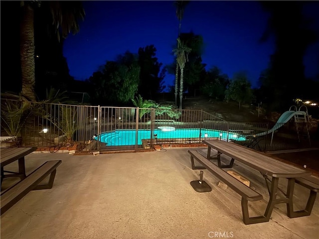 28726 Macklin Ave, Canyon Country, CA 91387 - pool at night with a water slide, a community pool, and a patio