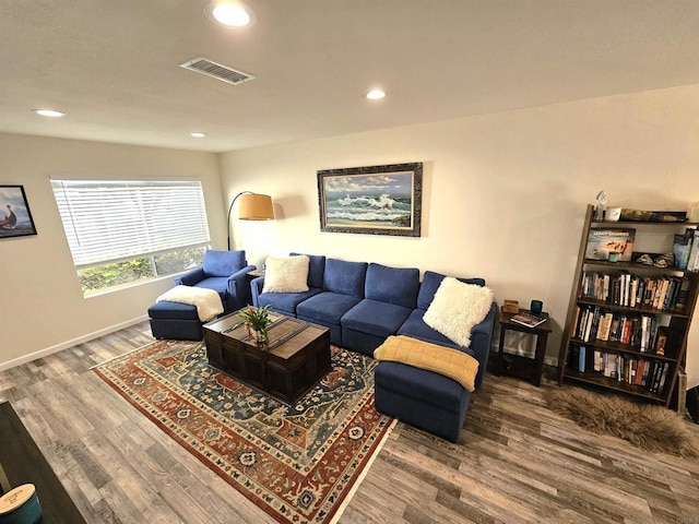 living room featuring wood finished floors, recessed lighting, and baseboards