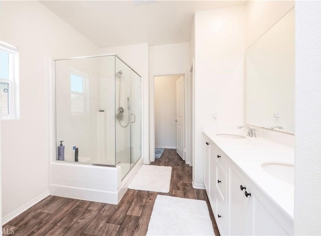 15667 San Diego Ln, Victorville, CA 92394 - full bath with a shower stall, wood finished floors, double vanity, and baseboards