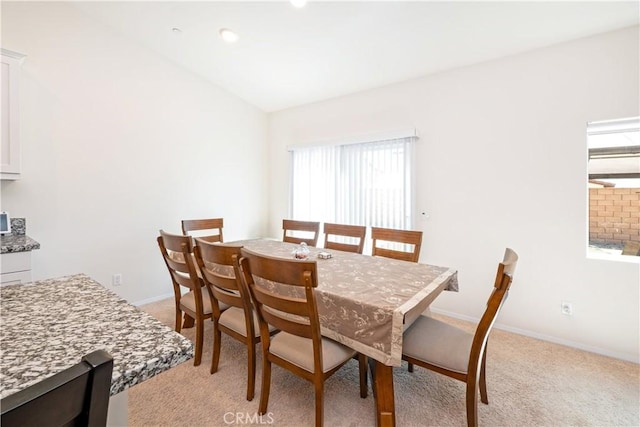 15667 San Diego Ln, Victorville, CA 92394 - dining space with light colored carpet, baseboards, and vaulted ceiling