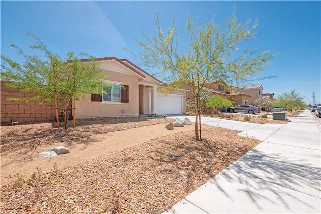 15667 San Diego Ln, Victorville, CA 92394 - ranch-style home featuring concrete driveway, an attached garage, and stucco siding