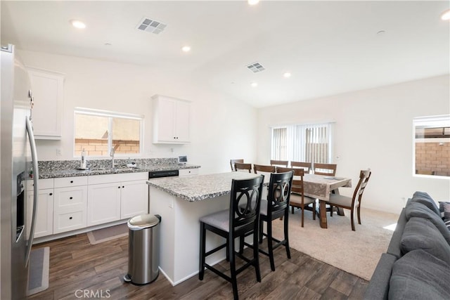 15667 San Diego Ln, Victorville, CA 92394 - kitchen featuring stainless steel fridge, open floor plan, a sink, lofted ceiling, and a kitchen island