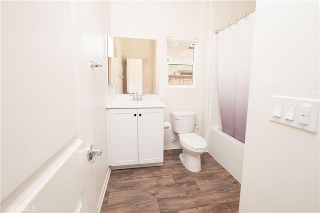 15667 San Diego Ln, Victorville, CA 92394 - bathroom featuring vanity, toilet, wood finished floors, and shower / bathtub combination with curtain