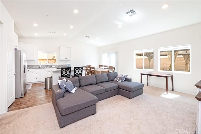 15667 San Diego Ln, Victorville, CA 92394 - living area featuring light carpet and vaulted ceiling