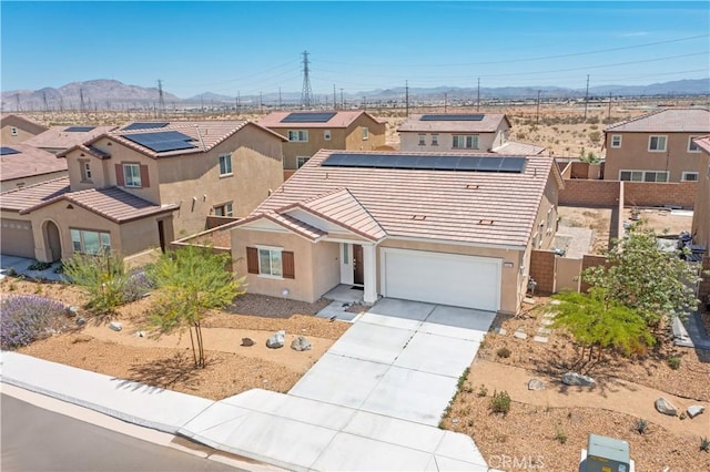 15667 San Diego Ln, Victorville, CA 92394 - view of front facade featuring a mountain view, a tile roof, concrete driveway, stucco siding, and a residential view