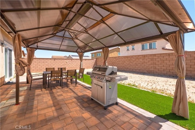 15667 San Diego Ln, Victorville, CA 92394 - fenced backyard featuring a gazebo, outdoor dining area, a patio area, and a grill