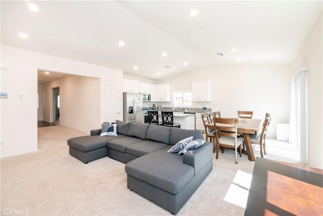 15667 San Diego Ln, Victorville, CA 92394 - living room featuring light carpet, vaulted ceiling, and recessed lighting