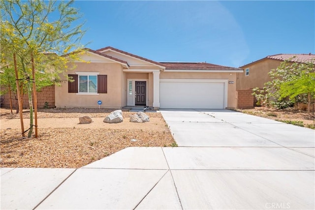 15667 San Diego Ln, Victorville, CA 92394 - ranch-style house featuring a garage, driveway, and stucco siding