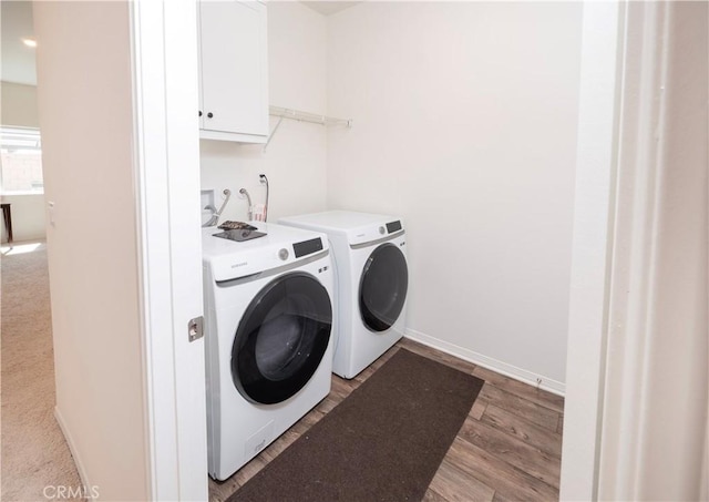 15667 San Diego Ln, Victorville, CA 92394 - laundry room with washer and dryer, cabinet space, light wood-style floors, and baseboards