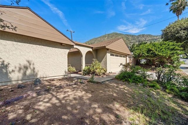 251 Mountain Crest Rd, Duarte, CA 91010 - view of front of house featuring stucco siding, an attached garage, and a mountain view