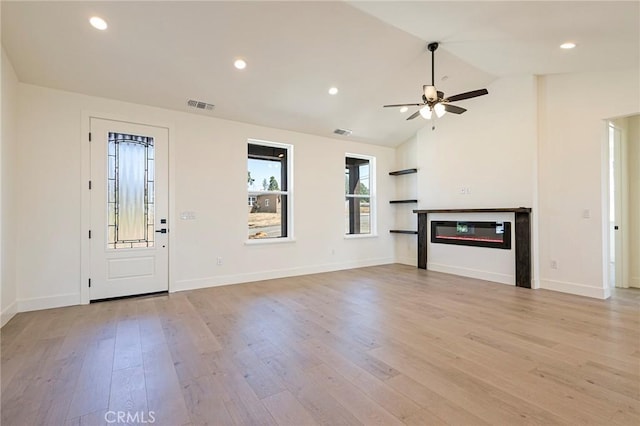 1890 Arrowhead Dr, Paradise, CA 95969 - unfurnished living room with a ceiling fan, light wood finished floors, a glass covered fireplace, lofted ceiling, and baseboards
