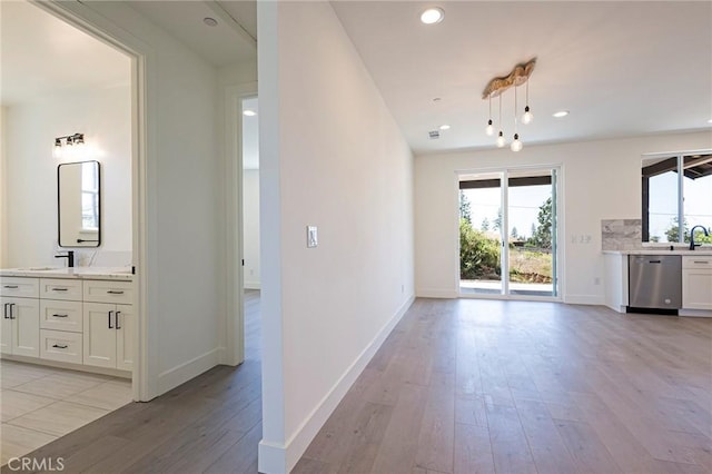 1890 Arrowhead Dr, Paradise, CA 95969 - unfurnished living room with light wood finished floors, baseboards, recessed lighting, and a sink