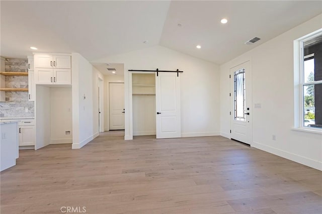 1890 Arrowhead Dr, Paradise, CA 95969 - unfurnished living room featuring a barn door, vaulted ceiling, light wood finished floors, baseboards, and recessed lighting