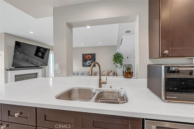 349 S Monte Vista St Unit 20, La Habra, CA 90631 - kitchen with open floor plan, a sink, light countertops, dark brown cabinets, and recessed lighting