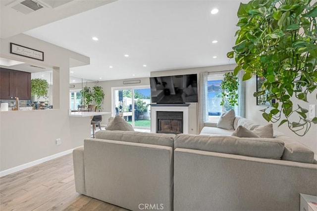 349 S Monte Vista St Unit 20, La Habra, CA 90631 - living area featuring light wood finished floors, baseboards, recessed lighting, and a glass covered fireplace