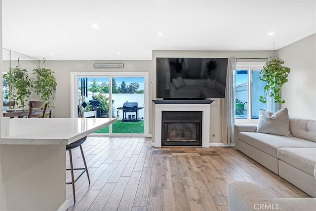 349 S Monte Vista St Unit 20, La Habra, CA 90631 - living area featuring light wood-style floors, plenty of natural light, a glass covered fireplace, and recessed lighting