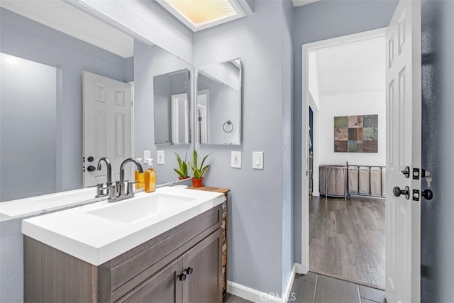 349 S Monte Vista St Unit 20, La Habra, CA 90631 - bathroom featuring vanity, wood finished floors, and baseboards