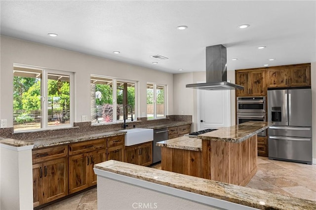 201 Valley View Dr, Oroville, CA 95966 - kitchen featuring appliances with stainless steel finishes, island exhaust hood, a sink, stone counters, and a center island