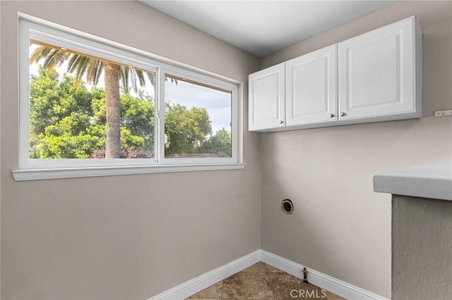 201 Valley View Dr, Oroville, CA 95966 - clothes washing area with cabinet space, healthy amount of natural light, baseboards, and tile patterned floors
