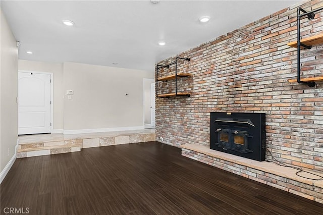 201 Valley View Dr, Oroville, CA 95966 - unfurnished living room with baseboards, wood finished floors, brick wall, recessed lighting, and a fireplace