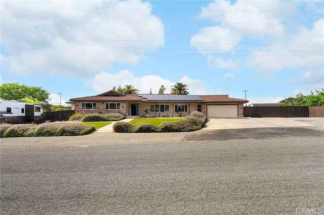 201 Valley View Dr, Oroville, CA 95966 - ranch-style home with fence, a garage, roof mounted solar panels, and driveway