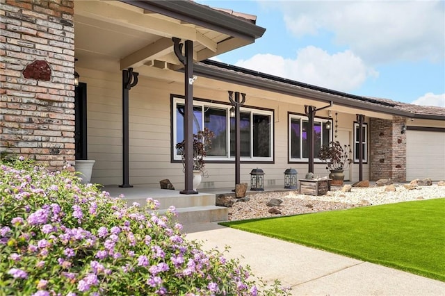 201 Valley View Dr, Oroville, CA 95966 - view of exterior entry featuring covered porch, a yard, and a garage