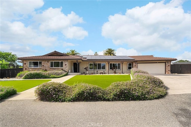 201 Valley View Dr, Oroville, CA 95966 - ranch-style home with an attached garage, solar panels, concrete driveway, and brick siding
