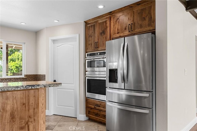 201 Valley View Dr, Oroville, CA 95966 - kitchen with appliances with stainless steel finishes, dark stone countertops, light tile patterned floors, recessed lighting, and baseboards