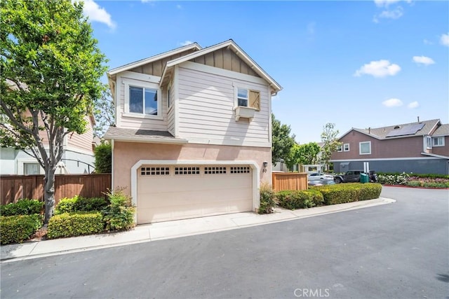 50 Bluff Cove Dr, Aliso Viejo, CA 92656 - view of front facade with a garage, board and batten siding, and stucco siding