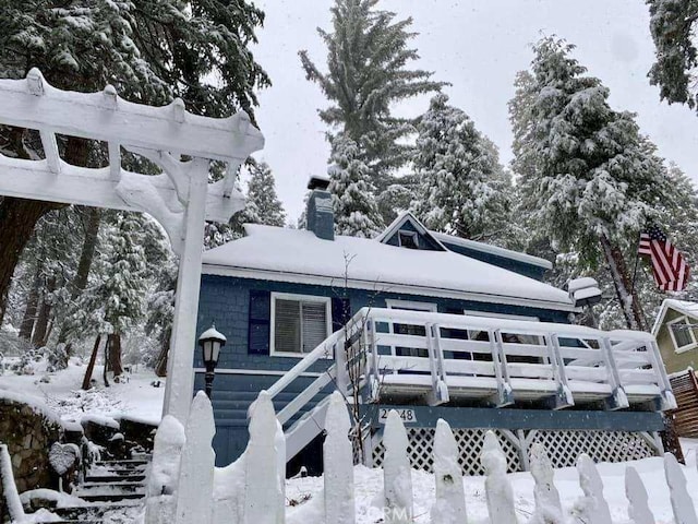 27048 State Highway 189, Blue Jay, CA 92317 - snow covered back of property featuring a chimney and a deck