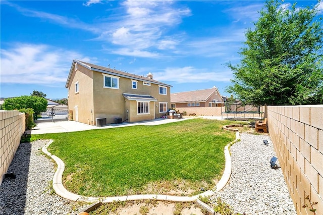 rear view of property featuring a patio area, a trampoline, stucco siding, cooling unit, and a gate