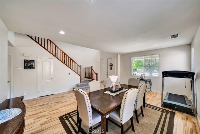 dining room with stairway, light wood-style flooring, baseboards, and recessed lighting