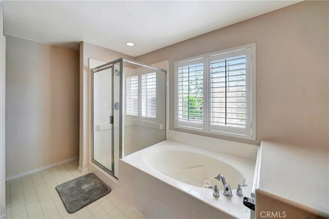 bathroom featuring a shower stall, a bath, tile patterned floors, and recessed lighting