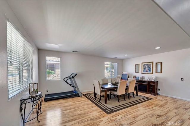dining space with light wood-style flooring, baseboards, and recessed lighting