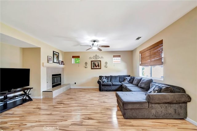 living room featuring light wood-type flooring and healthy amount of natural light