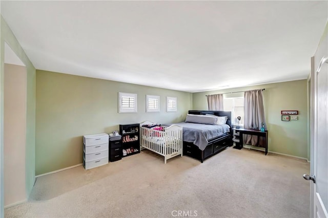 carpeted bedroom with baseboards