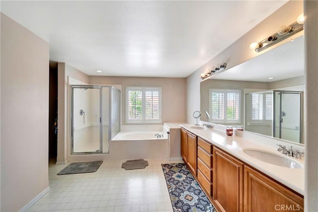 full bathroom with a stall shower, a bath, double vanity, and baseboards