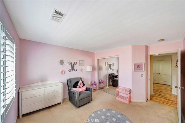 living area featuring light colored carpet and baseboards