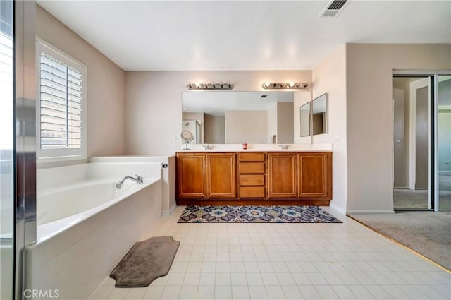 full bathroom with a garden tub, double vanity, and baseboards