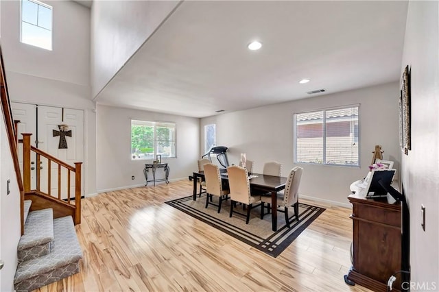 dining room featuring stairs, light wood-type flooring, baseboards, and recessed lighting