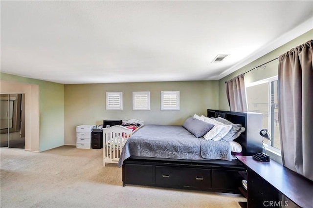 bedroom featuring light carpet