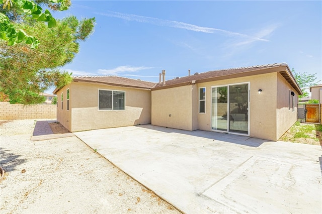 43839 58th St W, Lancaster, CA 93536 - rear view of house featuring stucco siding, a fenced backyard, and a patio area