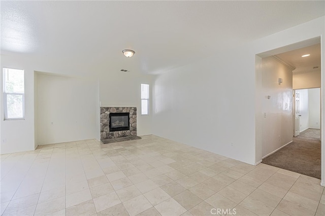 43839 58th St W, Lancaster, CA 93536 - unfurnished living room with a stone fireplace and light tile patterned floors
